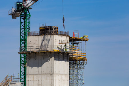 Workers working at height on the construction of a public facility. Collection of structural...