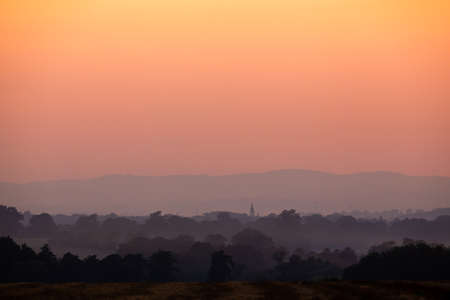 Orange sunset over the fields. Good lighting conditions, distant planes visible