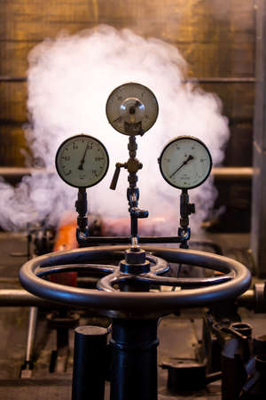 Old analog pressure gauges on an industrial steam plant. Photo taken in low light conditions, natural lightの写真素材