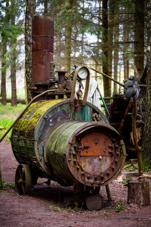 Illegal alcohol production apparatus positioned among the trees in the forest. Photo taken in low...