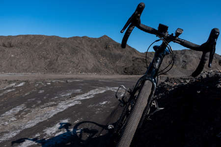 Gravel bike against background. of blue sky. Adventure on a gravel bike on the industrial area full...