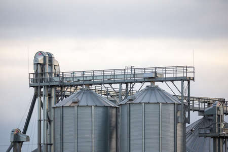 Close-up on steel grain silo in the fields. Photo taken in natural lighting, soft light