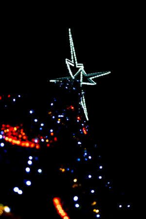 Close up of colorful lights on a Christmas tree. Photo taken at night. Lamps woven into the tree...