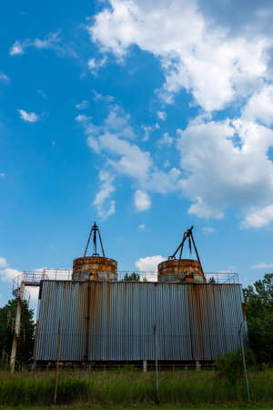 Closed cooling towers in an abandoned factory. Photo taken on a sunny day in natural light.の写真素材