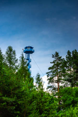 High fire watchtower in the forest. Photo taken on a cloudy day with natural light.の写真素材