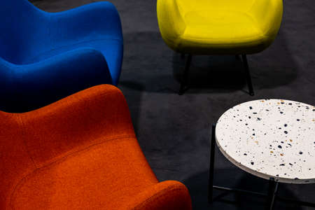 An empty meeting place during a pandemic. Colorful office chairs at the meeting place. lack of people. A place lit by atmospheric, artificial light.の写真素材