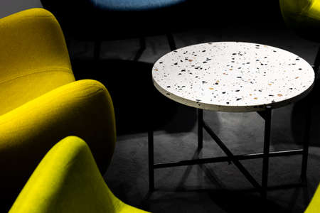 An empty meeting place during a pandemic. Colorful office chairs at the meeting place. lack of people. A place lit by atmospheric, artificial light.の写真素材