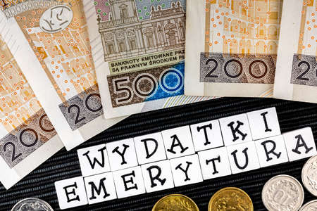 The wording expenses pensions translated as expenses pensions and many Polish coins and banknotes on...
