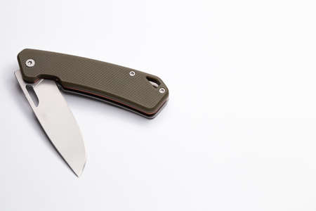 A small folding hunting knife isolated on the white background. Photo taken under soft artificial...