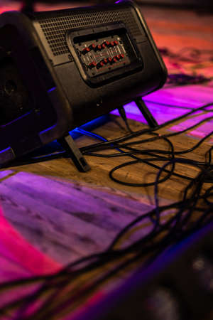 Listening stage monitor on a wooden stage. Object illuminated with colored light.の写真素材