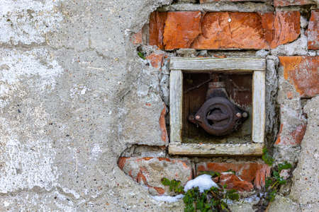 Old electrical on-off switch on the outside wall of the building. Picture taken in soft, natural light.の写真素材