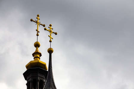 Orthodox cross on top of the church against the cloudy sky. Photo taken in natural light of cloudy dayの写真素材