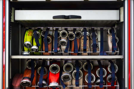 Set of water hoses inside fire truck. Picture made in soft, natural light.の写真素材