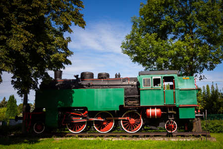 A steam locomotive standing outside of historic locomotive shed. The shot was taken in natural lighting conditionsの写真素材