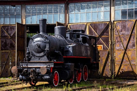 A steam locomotive standing outside of historic locomotive shed. The shot was taken in natural...