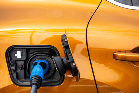 Close up for the socket of the electric car during charging. Modern electro mobility in everyday...