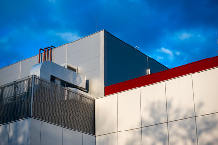Ventilation and air conditioning systems on the roof of a modern building. HVAC system photographed against a blue sky on a sunny afternoonのeditorial素材