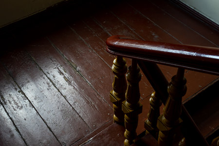 The interior of a wooden staircase in an old residential tenement house. Photo taken in natural lighting conditions.の写真素材