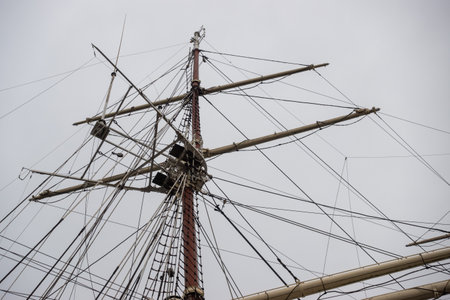 Rigging masts on a deep-sea sailing ship. The mast photographed against a cloudy sky