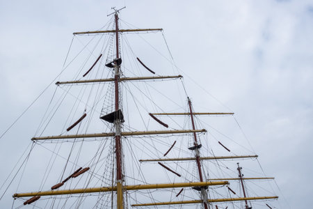 Rigging masts on a deep-sea sailing ship. The mast photographed against a cloudy sky
