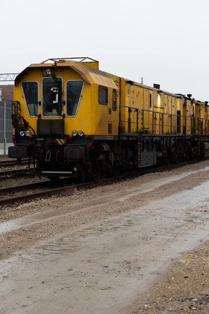 A yellow technical train for grinding rails standing on a railway siding. Equipment for maintaining...