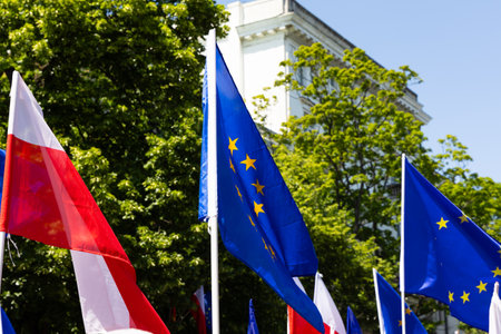 Polish and European Union flags on a protest march. A manifestation of sympathy for the European Union. Photo taken on a sunny day.の写真素材