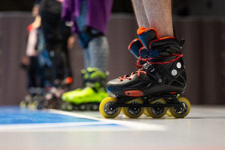 Close-up of roller skates of people training figure skating in a sports hall. Photo taken with...