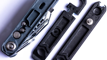 Black bicycle multifunctional multitool unfolded on a white background. Chrome steel tools. Tools for bicycle self-repairing.の写真素材