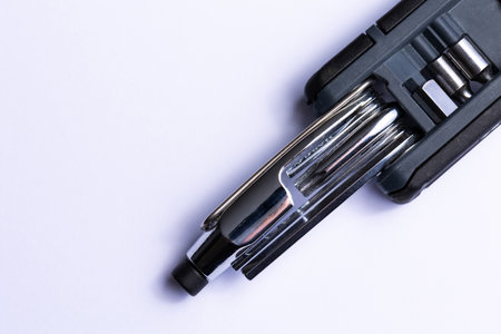 Black bicycle multifunctional multitool unfolded on a white background. Chrome steel tools. Tools for bicycle self-repairing.の写真素材