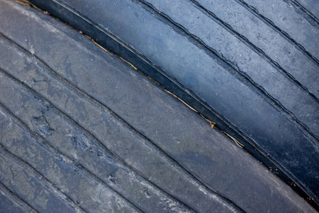 Worn and damaged tread of old tires lying in a landfill. Decreased road safety and environmental pollution from rubber wasteの写真素材