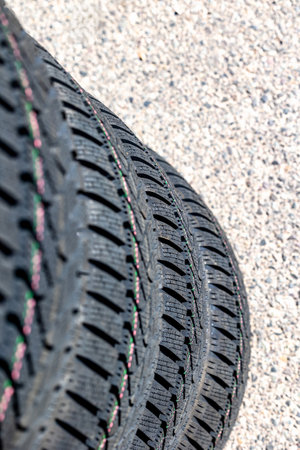 Sharp tread of new winter tires ready for the seasonal change. New tires are important for...