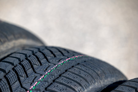 Sharp tread of new winter tires ready for the seasonal change. New tires are important for increasing road safetyの写真素材