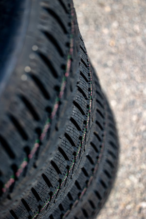Sharp tread of new winter tires ready for the seasonal change. New tires are important for increasing road safetyの写真素材