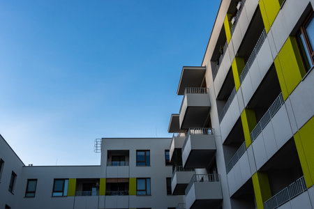 Facades of modern apartment blocks against a blue sky. Photos taken in afternoon light.