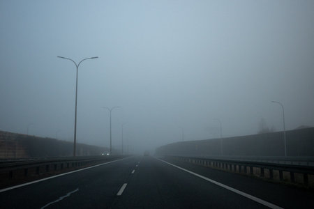Driving in foggy weather on the highway. Driving in autumn and winter weather.