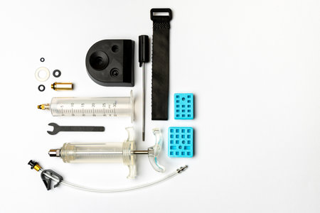 Hydraulic bicycle brake bleeding and oil change kit. Hydraulic brake service tools on a white background. Picture taken with flash lightの写真素材
