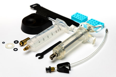 Hydraulic bicycle brake bleeding and oil change kit. Hydraulic brake service tools on a white background. Picture taken with flash lightの写真素材