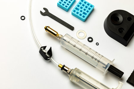 Hydraulic bicycle brake bleeding and oil change kit. Hydraulic brake service tools on a white background. Picture taken with flash lightの写真素材