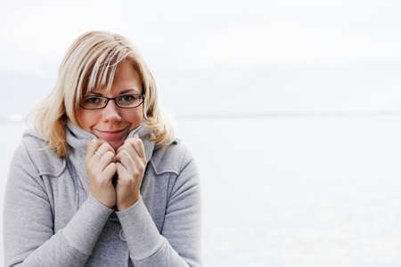 Cute woman in warm winter outfit protects from the cold.