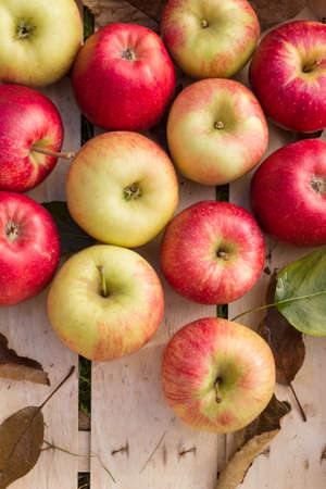 Fresh organic apples arranged in a wooden box as a natural still life for healthy and vegetarian...