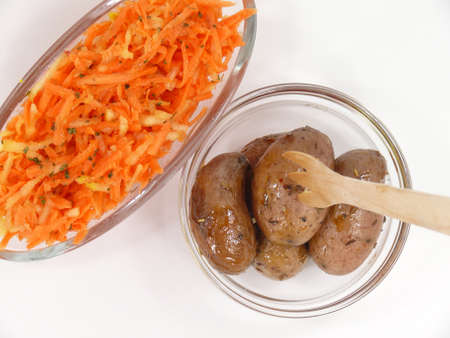 raw carrot salad and baked potatoesの写真素材