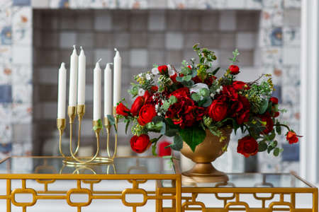 Decor of red roses and candles on a white backgroundの写真素材