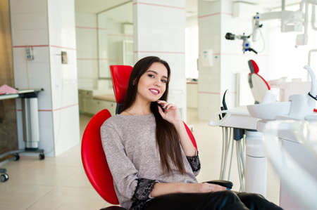 Beautiful girl smiles in the dental chair..の写真素材