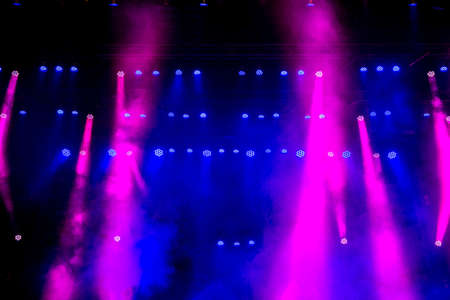 Beautiful concert light on an empty stage in the smoke. Disco and laser show.の写真素材
