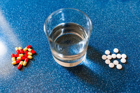 closeup of painkiller tablet in glass of water. vertical shape, copy spaceの写真素材