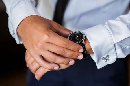 Man looks at the time on the clock.