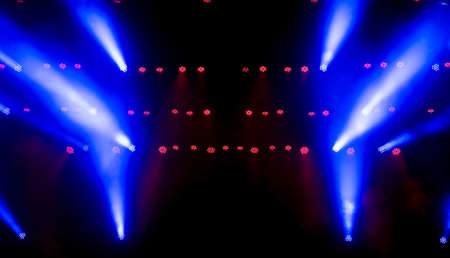Stage light with colored spotlights and smoke.の写真素材