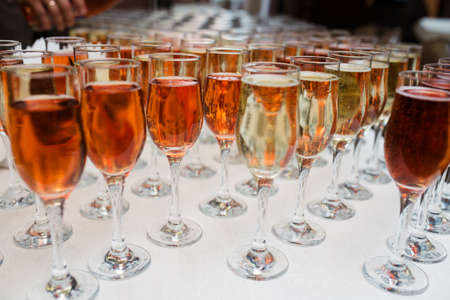Glasses of red, rose and white wine with sunshine shadow effect. Concept of wine tasting.