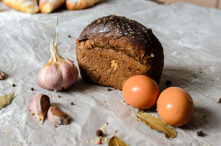 Still life of bread, eggs, garlic and spices