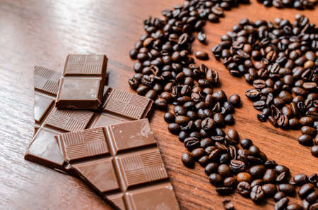 Coffee beans and chocolate on the tableの写真素材
